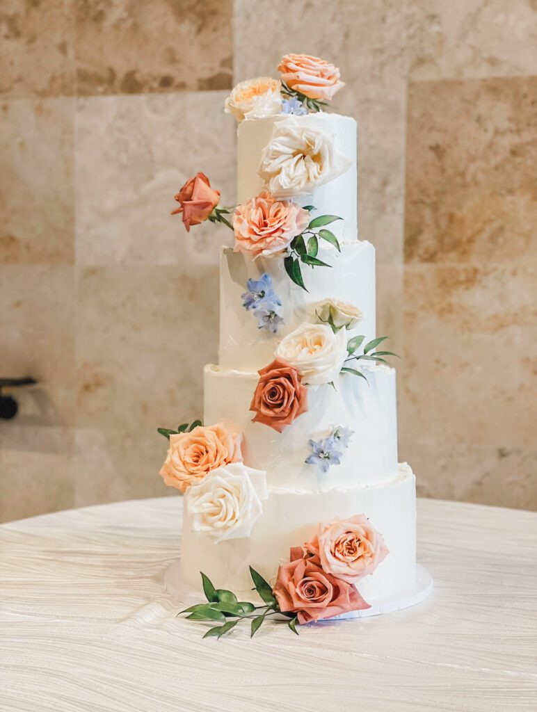 four tier buttercream cake with light texture and lots of colorful florals