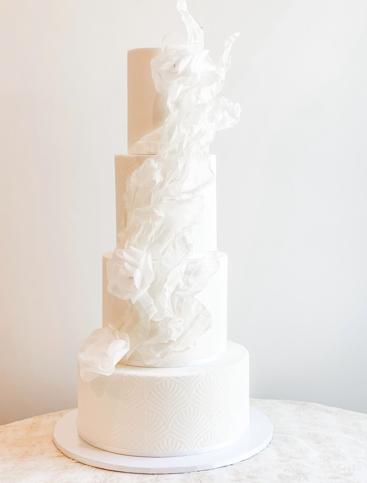 luxury modern wedding cake with sails and paper flowers